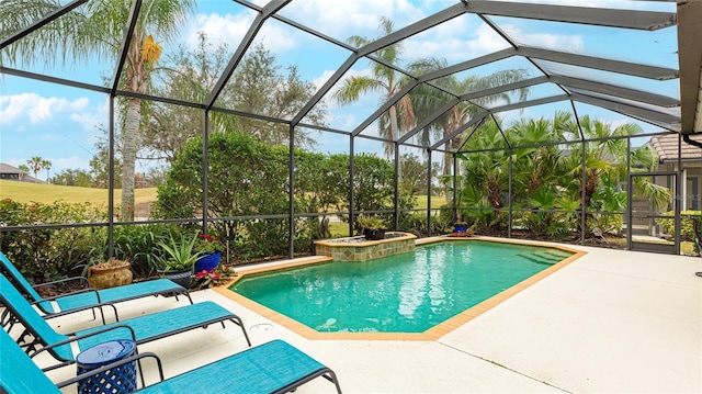 view of pool with a patio and glass enclosure