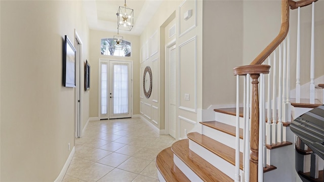 7244 Orchid Island Pl, Bradenton, FL 34202 - entryway with a chandelier, stairway, and light tile patterned floors