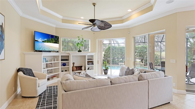 7244 Orchid Island Pl, Bradenton, FL 34202 - living area featuring a raised ceiling, ceiling fan, light tile patterned flooring, and crown molding
