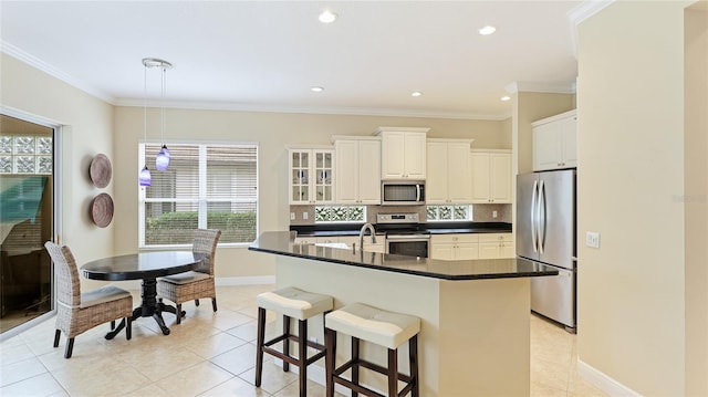 7244 Orchid Island Pl, Bradenton, FL 34202 - kitchen featuring appliances with stainless steel finishes, dark countertops, plenty of natural light, decorative backsplash, and ornamental molding