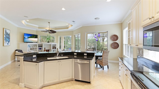 7244 Orchid Island Pl, Bradenton, FL 34202 - kitchen with stainless steel appliances, light tile patterned floors, open floor plan, ceiling fan, and ornamental molding