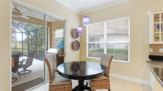 7244 Orchid Island Pl, Bradenton, FL 34202 - dining room featuring plenty of natural light, crown molding, light tile patterned flooring, a sunroom, and ceiling fan