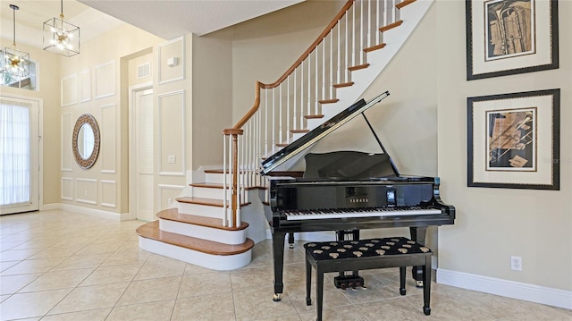 7244 Orchid Island Pl, Bradenton, FL 34202 - tiled entryway featuring stairway and a chandelier