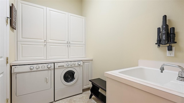 7244 Orchid Island Pl, Bradenton, FL 34202 - laundry area with cabinet space, washer and clothes dryer, and light tile patterned flooring