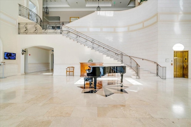 7244 Orchid Island Pl, Bradenton, FL 34202 - common area featuring a towering ceiling, ornamental molding, and stairs