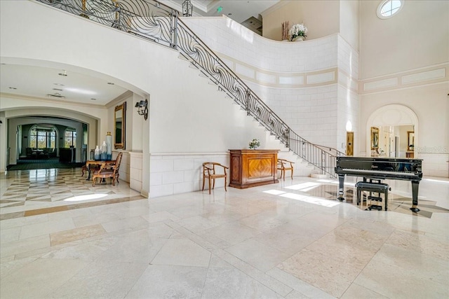 7244 Orchid Island Pl, Bradenton, FL 34202 - community lobby with a high ceiling, ornamental molding, stairway, and a wainscoted wall