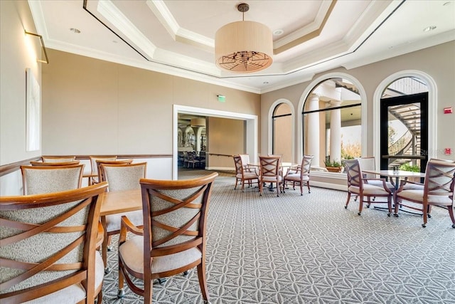 7244 Orchid Island Pl, Bradenton, FL 34202 - dining space featuring light carpet, a tray ceiling, and crown molding