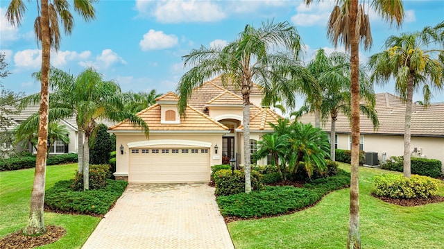 7244 Orchid Island Pl, Bradenton, FL 34202 - view of front of home with stucco siding, an attached garage, decorative driveway, and a front lawn