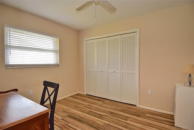 office space with ceiling fan and light hardwood / wood-style floors