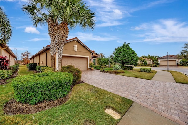 view of front of house featuring a garage and a front lawn