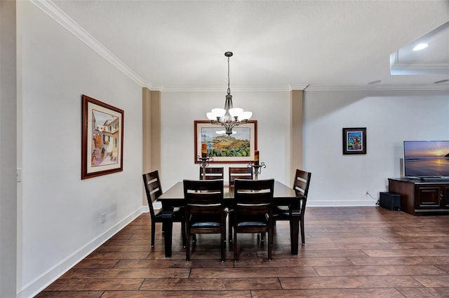 dining area with dark wood-type flooring, crown molding, and a chandelier