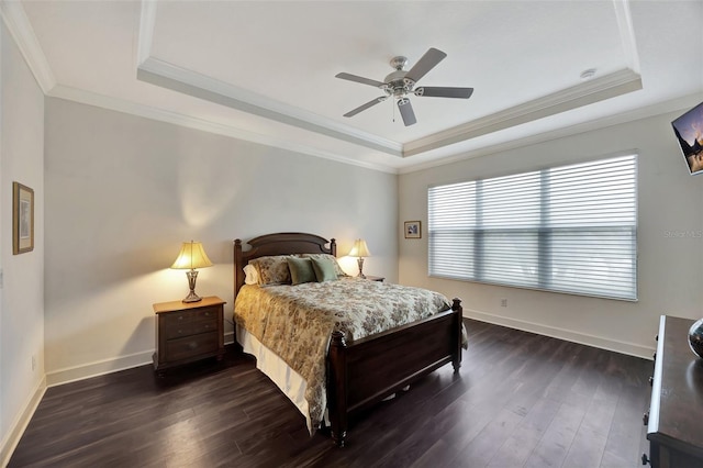 bedroom with dark hardwood / wood-style floors, ornamental molding, a raised ceiling, and ceiling fan