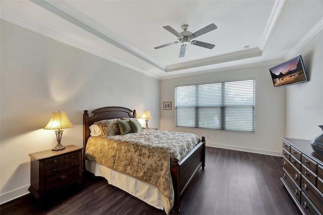 bedroom featuring crown molding, a tray ceiling, dark hardwood / wood-style floors, and ceiling fan