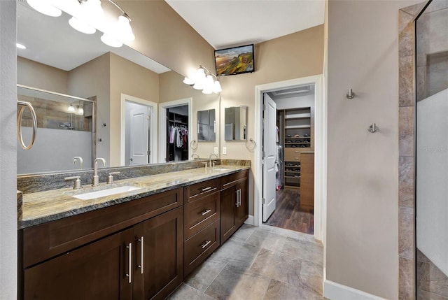 bathroom with vanity and a shower with door