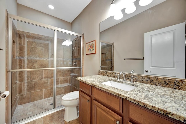 bathroom featuring vanity, an enclosed shower, and toilet