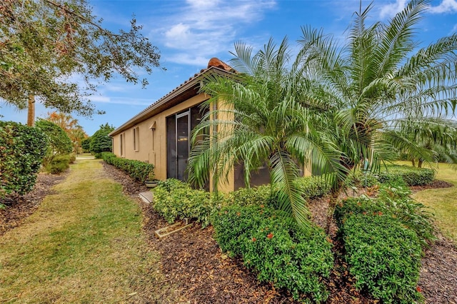 view of property exterior with a lawn