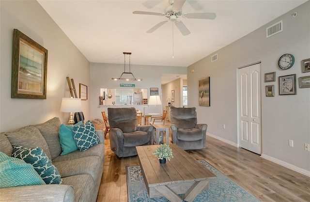 living room featuring ceiling fan and light hardwood / wood-style flooring