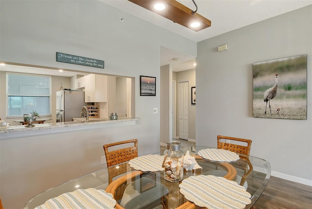 dining space with dark wood-type flooring and sink