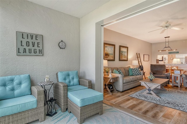 living room with hardwood / wood-style floors and ceiling fan