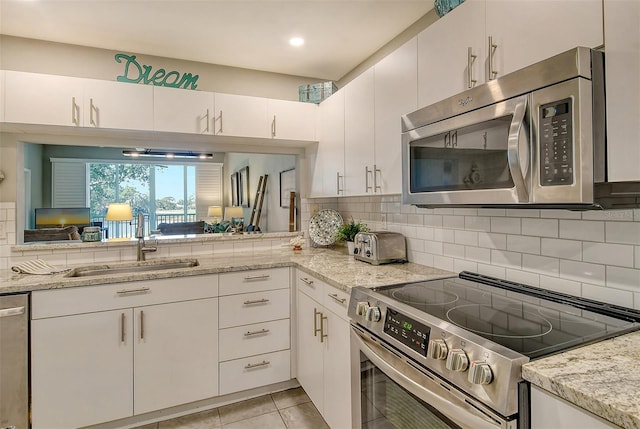 kitchen with white cabinetry, sink, and appliances with stainless steel finishes