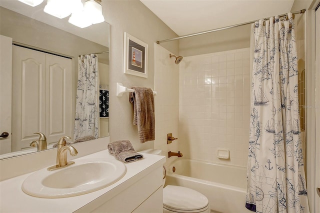 full bathroom featuring vanity, shower / bath combination with curtain, and toilet