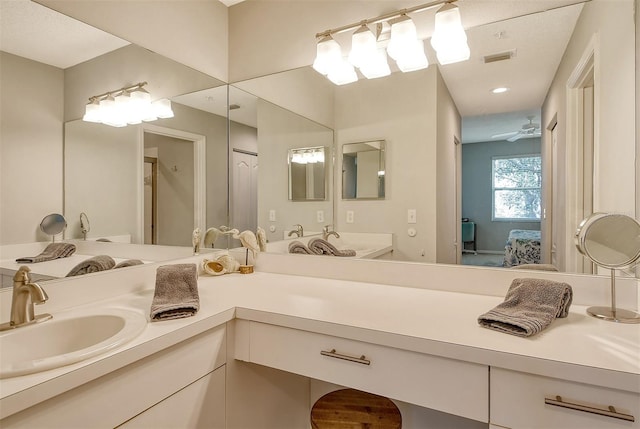 bathroom featuring ceiling fan and vanity