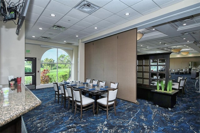 dining space with a drop ceiling