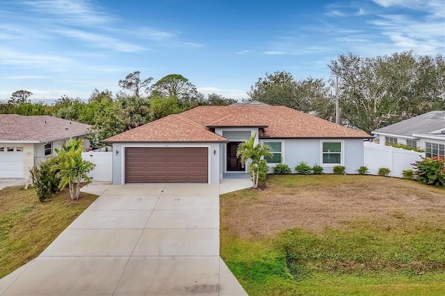 ranch-style home with a front lawn and a garage