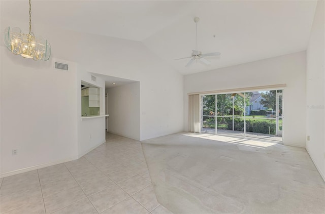 carpeted empty room with ceiling fan and high vaulted ceiling