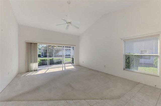 spare room featuring ceiling fan, light colored carpet, and high vaulted ceiling