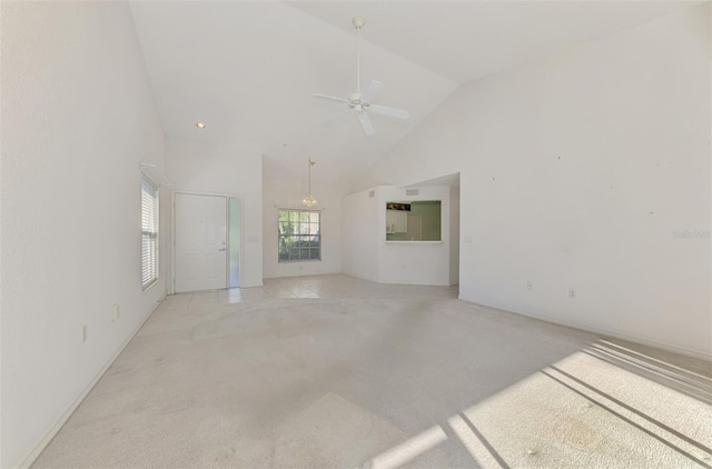 interior space featuring high vaulted ceiling, light colored carpet, and ceiling fan