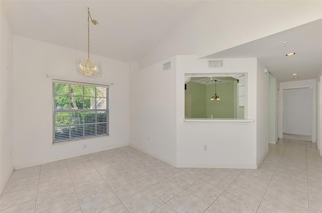 tiled spare room with vaulted ceiling and an inviting chandelier