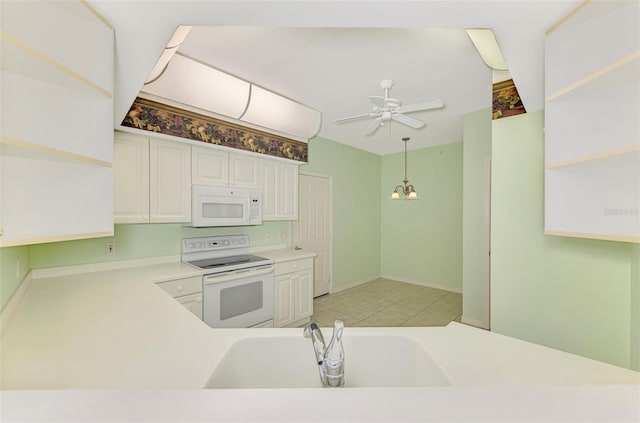 kitchen with sink, white appliances, decorative light fixtures, ceiling fan, and white cabinets