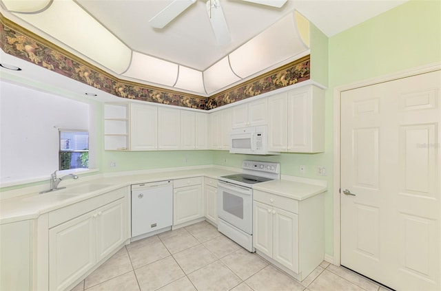 kitchen featuring sink, white appliances, light tile patterned floors, ceiling fan, and white cabinetry