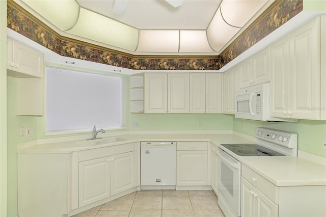 kitchen featuring white cabinetry, sink, light tile patterned floors, and white appliances