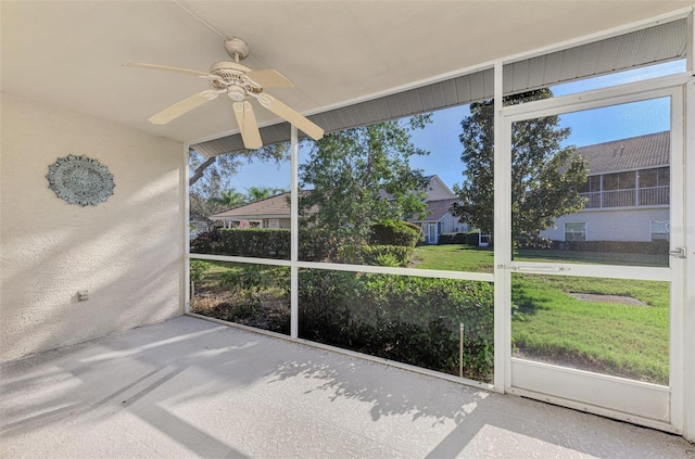 unfurnished sunroom with a wealth of natural light and ceiling fan