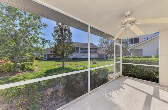 unfurnished sunroom featuring ceiling fan