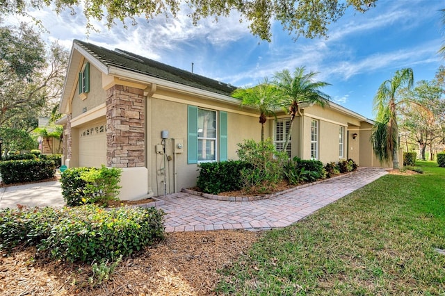 view of front of home with a garage and a front yard