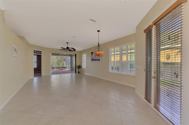 empty room featuring light tile patterned flooring and ceiling fan