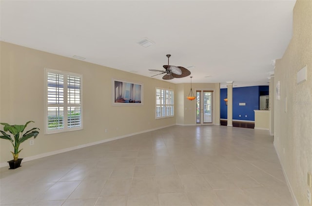 spare room with ceiling fan and light tile patterned floors