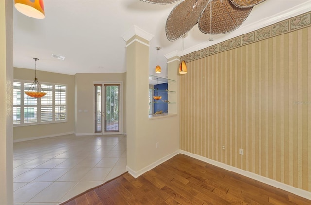 entrance foyer featuring wood-type flooring and crown molding