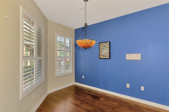 empty room with dark hardwood / wood-style floors