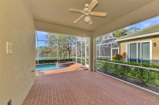 unfurnished sunroom with ceiling fan