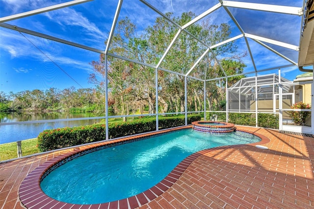 view of pool featuring an in ground hot tub, a water view, glass enclosure, and a patio