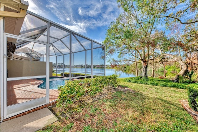 view of yard featuring a water view, a lanai, and a patio