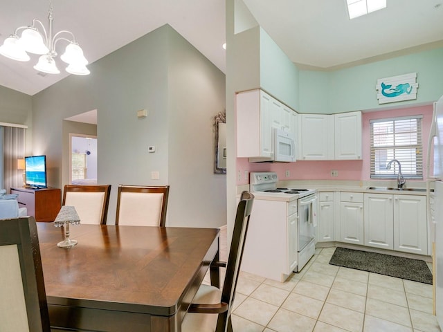 kitchen with white cabinets, decorative light fixtures, white appliances, and light tile patterned floors