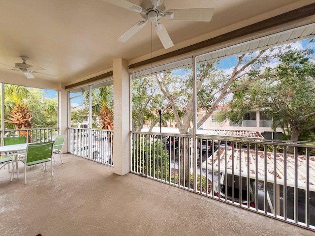 unfurnished sunroom featuring ceiling fan