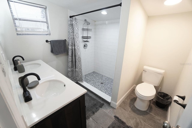 bathroom featuring toilet, vanity, and a shower with curtain