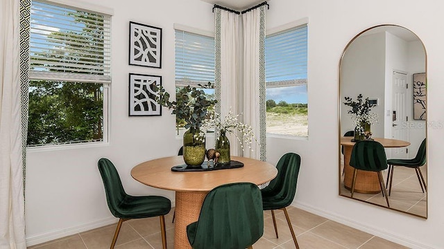 dining space featuring light tile patterned floors