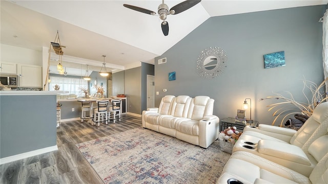 living room featuring lofted ceiling, dark hardwood / wood-style flooring, and ceiling fan